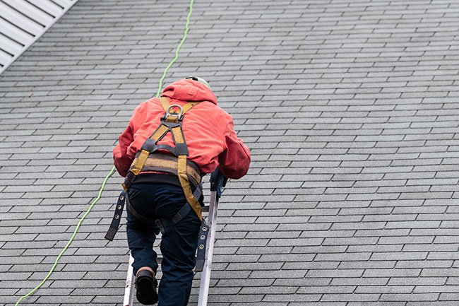 Contractor inspecting roof