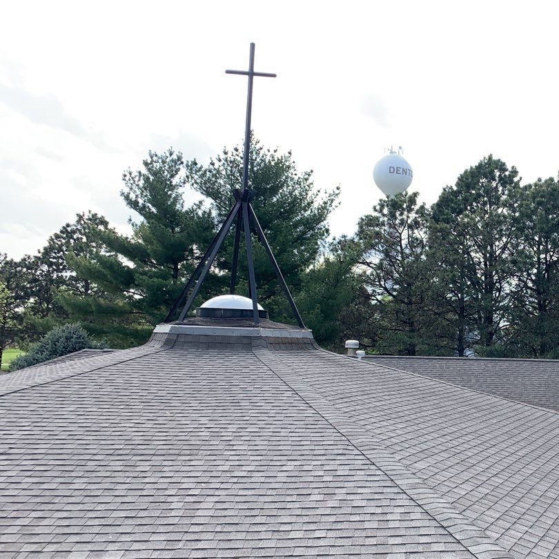 Steeple of church roofing with shingles after project
