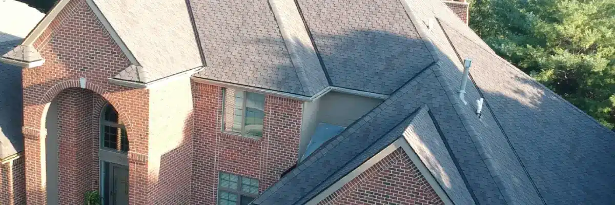 Aerial view of a residential shingle roof illustrating factors in how long is a roof warranty by Anchor Roofing in Omaha, NE