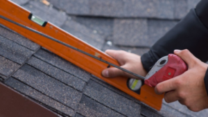 Anchor Roofing contractor measuring a black roof for roof replacement omaha, NE