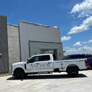 Anchor Roofing truck parked in front of a commercial building in Omaha, NE