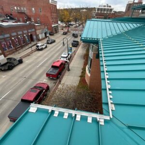 A turquoise metal roof with a street view below in Omaha, NE