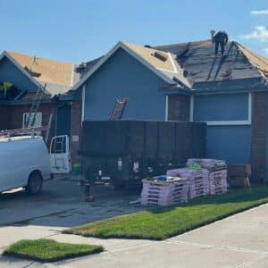 Anchor Roofing contractor on top of a roof in a process of roof replacement in Omaha.