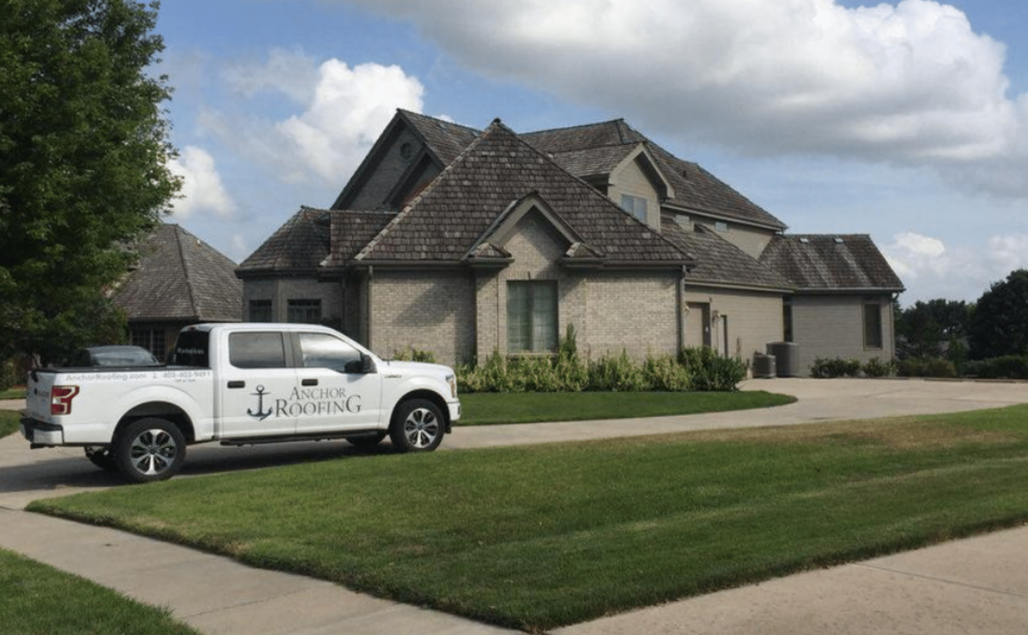 A large residential home with a steep roofline, representing roof replacement services in Omaha, Nebraska.