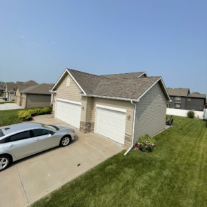 A residential home with a new roof in a suburban neighborhood, representing roof replacement services in Omaha, Nebraska.