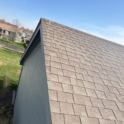 A steep pitched brown roof that had a roof replacement done by Anchor Roofing in Omaha