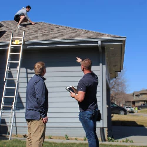 Roofing inspection in progress, with a professional assessing the condition of the roof for potential issues."