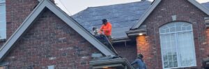 Roof pitch being measured using a level tool to determine the angle of the roof.