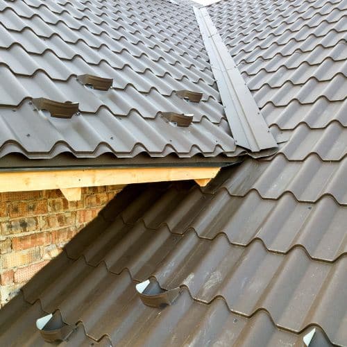 Open valley gutter system showing water drainage pathway between two roof slopes
