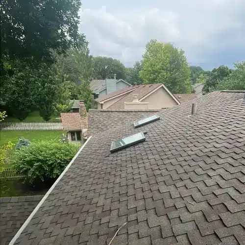 Skylights installed on residential shingle roof inspected for possible leaks, demonstrating roof leak replacement by Anchor Roofing