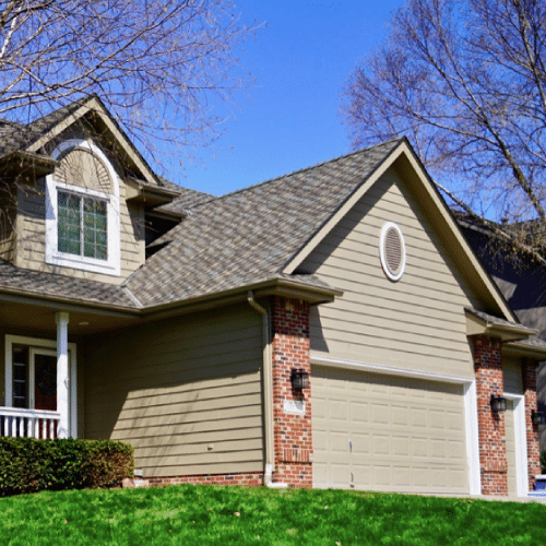 Asphalt shingles on two-story suburban home by Anchor Roofing in Omaha
