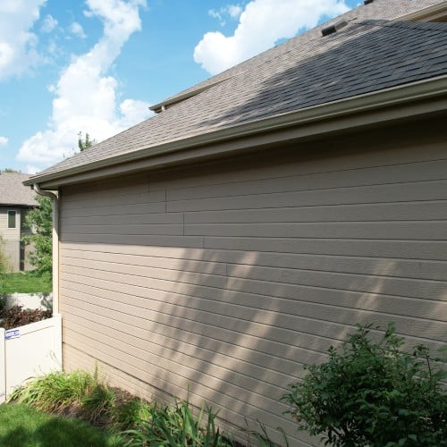 Beige lap siding on Omaha home exterior by Anchor Roofing in Omaha, NE