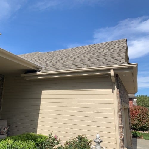 Light tan lap siding on residential home exterior by Anchor Roofing in Omaha, NE