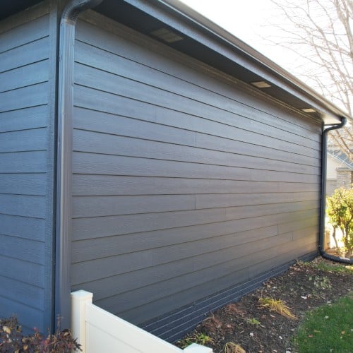 Modern charcoal siding installed on residential garage wall by Anchor Roofing in Omaha, NE