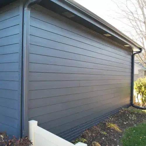 Modern Omaha home exterior showcasing fiber cement siding next to vinyl siding panels by Anchor Roofing in Omaha, Nebraska