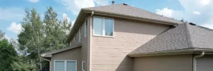 Close-up comparison of fiber cement vs vinyl siding materials on Omaha home exteriors by Anchor Roofing in Omaha, Nebraska