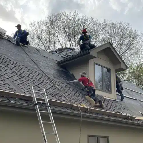 Roofing crew performing siding installation and roof replacement by Anchor Roofing in Omaha, Nebraska