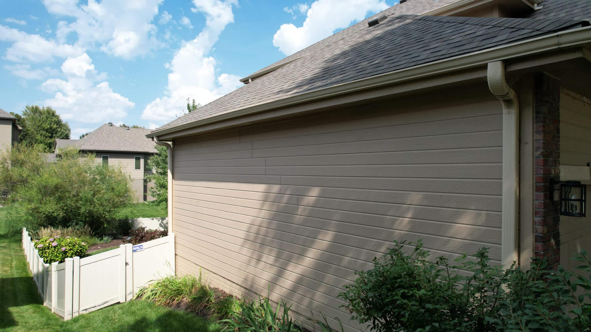 Updated residential exterior featuring new roofing and siding upgrades by Anchor Roofing