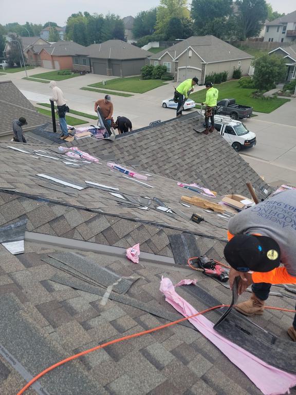 Roofing contractors performing shingle replacement and inspection work by Anchor Roofing