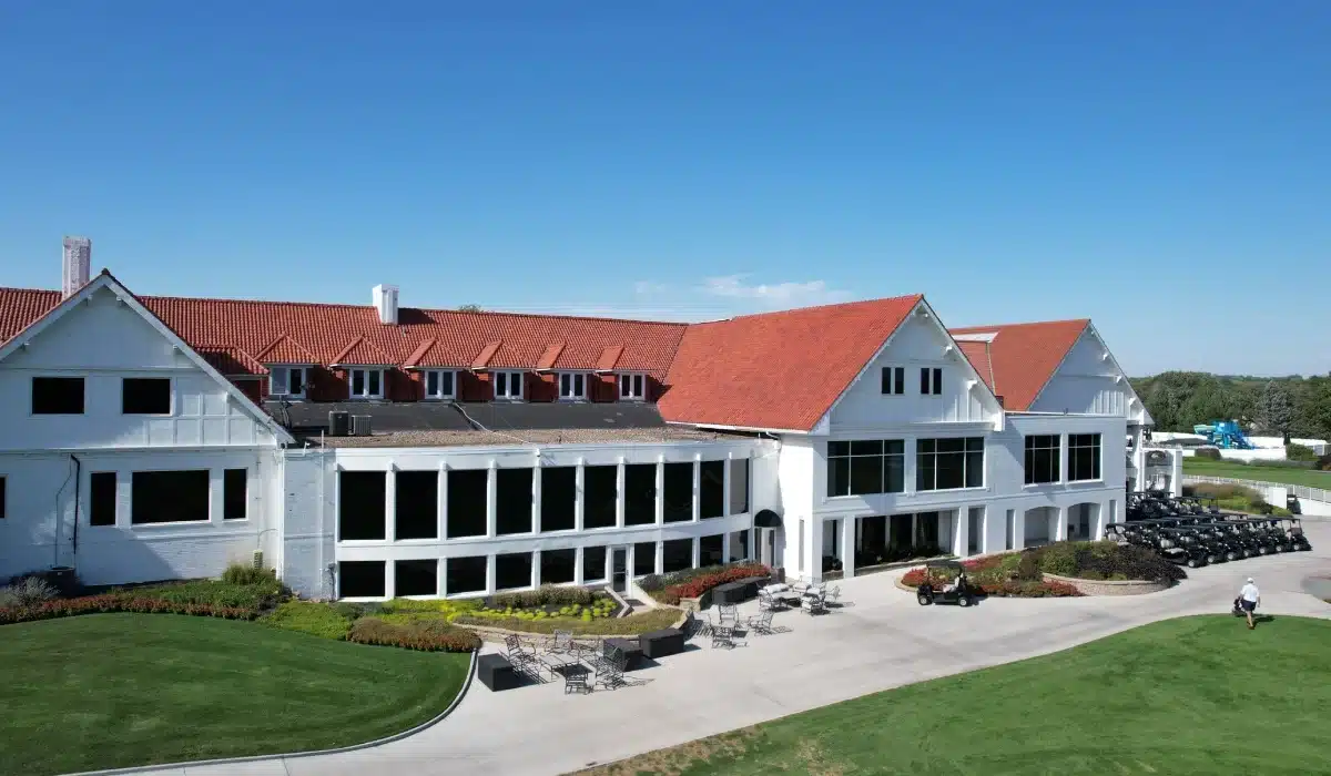 Finished clubhouse after an iconic Omaha roof replacement using Brava Spanish tile and Carlisle EPDM at Happy Hollow Country Club by Anchor Roofing in Omaha