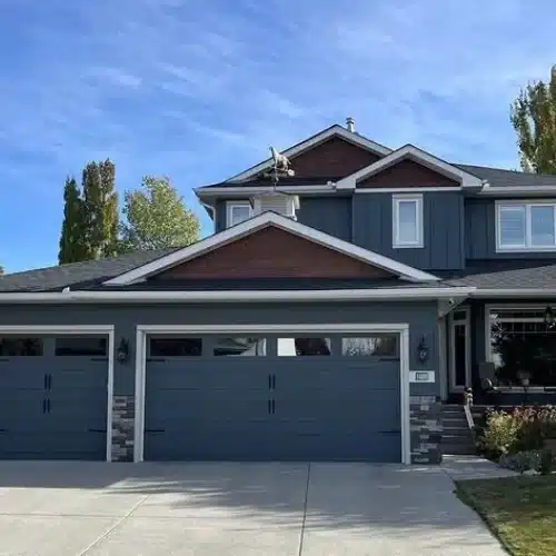 Completed siding upgrade on a two-story home with attached garage by Anchor Roofing in Omaha