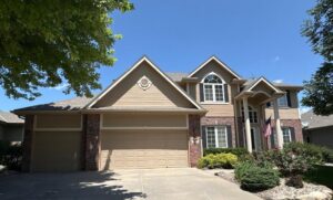 Front exterior of Omaha home before siding installation by Anchor Roofing