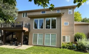 Home exterior with faded and deteriorating MDF siding before replacement by Anchor Roofing showing visible wear and reduced curb appeal