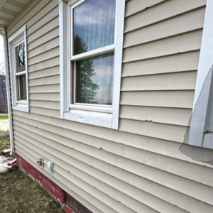 Freshly installed horizontal siding with white trim around a window on a home exterior in Nebraska