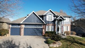 Front exterior of Omaha home after siding installation by Anchor Roofing showing improved curb appeal and finished exterior
