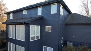 Omaha home exterior with bold deep ocean siding color after installation by Anchor Roofing featuring modern cohesive design and improved curb appeal