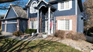 After siding installation on Omaha home featuring bold deep ocean exterior and modern architectural design by Anchor Roofing