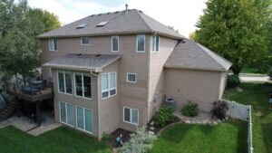 Aerial view of Omaha home with updated siding by Anchor Roofing highlighting exterior renovation investment