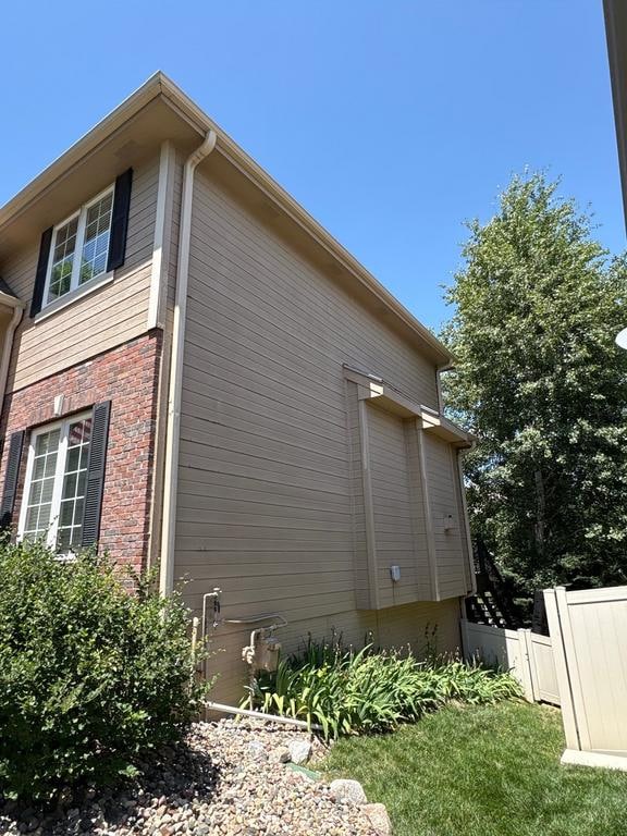 Side view of house with new siding installation by Anchor Roofing in Omaha showcasing exterior upgrade quality