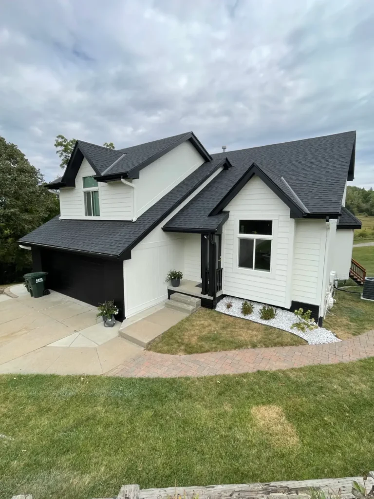 Modern Omaha home featuring a newly installed dark asphalt shingle roof, clean white siding, and updated exterior details completed by Anchor Roofing.