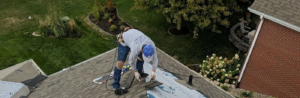 A roofer laying down asphalt shingles on branded underlayment to reinforce commercial roof maintenance commercial roofing services in Omaha by Anchor Roofing