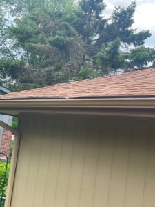 Residential siding and roof corner highlighting replace vs repair storm damaged roof service in Omaha by Anchor Roofing