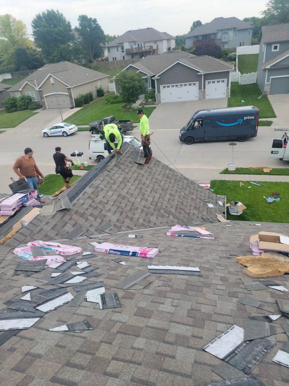 Anchor Roofing crew performing replace vs repair storm damaged roof service in Omaha by Anchor Roofing