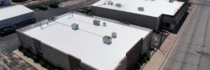 White reflective coating on flat roofs showing commercial roof coating benefits in Omaha by Anchor Roofing