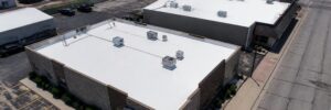 White reflective coating on flat roofs showing commercial roof coating benefits in Omaha by Anchor Roofing