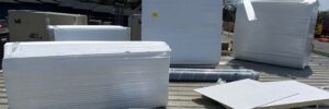 Section of commercial roof with white coating and rooftop equipment, Commercial Roof Restoration in Omaha by Anchor Roofing