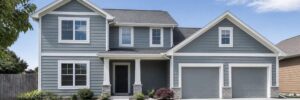 Two-story home with gray James Hardie lap siding and white trim, James Hardie siding in Nebraska by Anchor Roofing