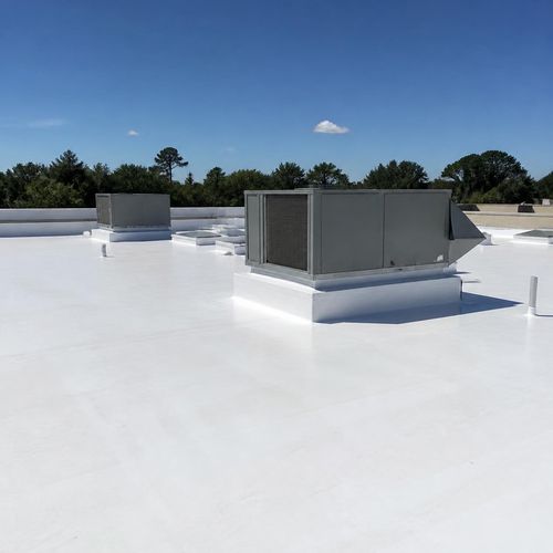 Restored commercial roof coating system on a commercial building by Anchor Roofing