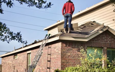 an employee of a roofing company walks on an Omaha roof