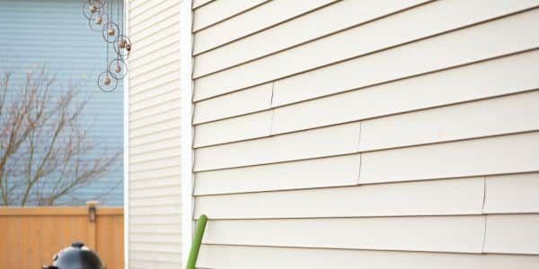 cream colored siding that is being inspected by Anchor Roofing in Omaha