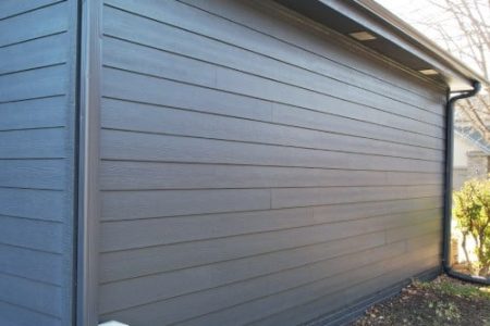 Modern charcoal siding installed on residential garage wall by Anchor Roofing in Omaha, NE