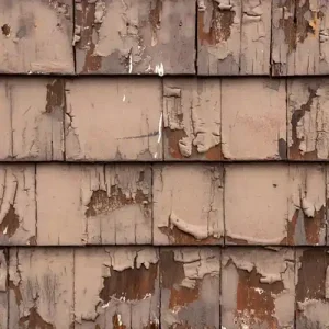 Close-up of peeling paint and damaged siding boards inspected by siding contractor at Anchor Roofing in Omaha