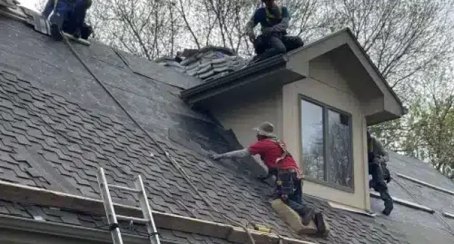 Roofing crew performing siding installation and roof replacement by Anchor Roofing in Omaha, Nebraska