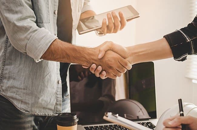 Contractor shaking hands with customer Contractor shaking hands with customer