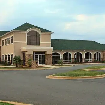 commercial building with a green roof and large windows