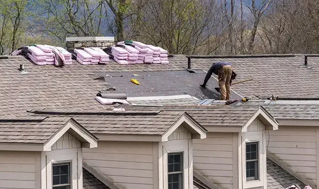 residential roof in the middle of a home roof replacement by a roofing contractor